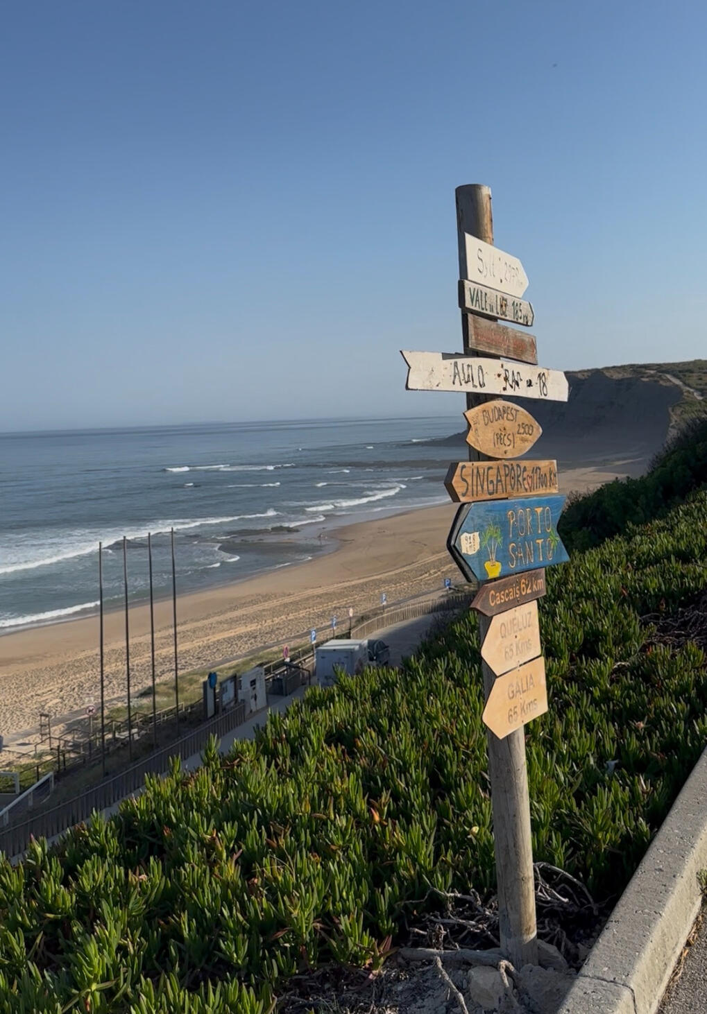 beach with small waves and sign