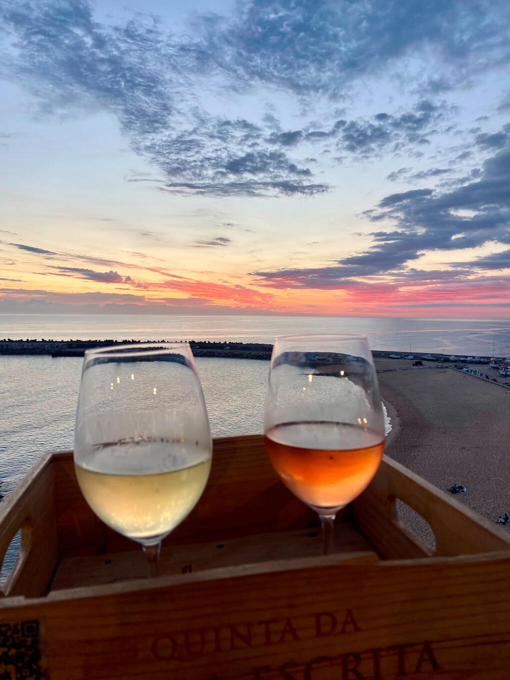 sunset over ocean with wine