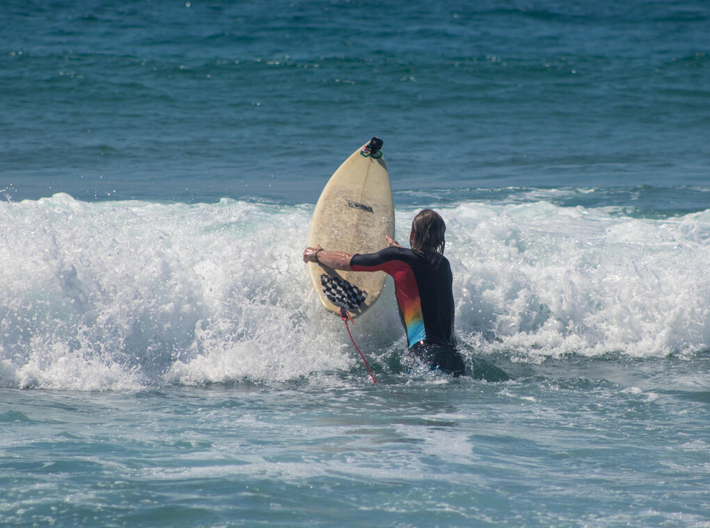 surfer with shortboard in between waves