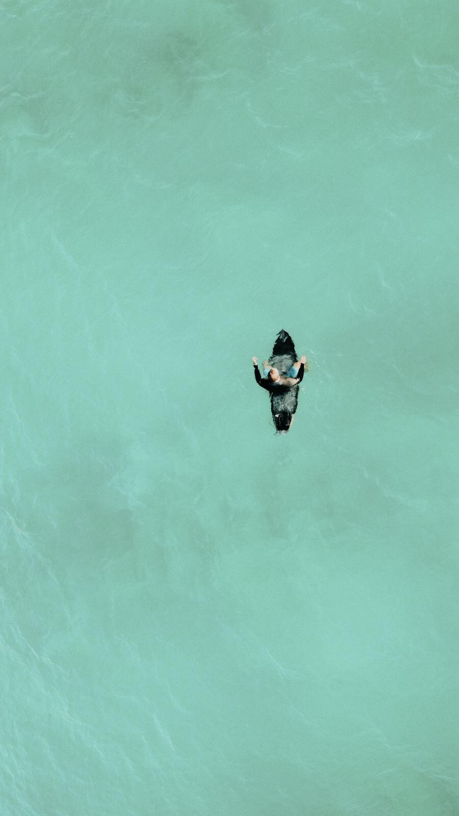 surfer in turquoise water