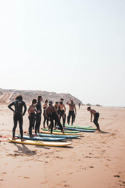 beginners at beach with surf teacher